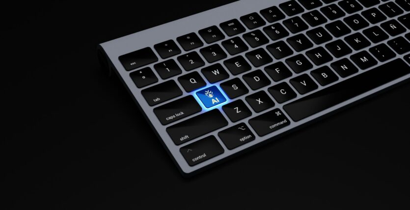 a black keyboard with a blue button on it