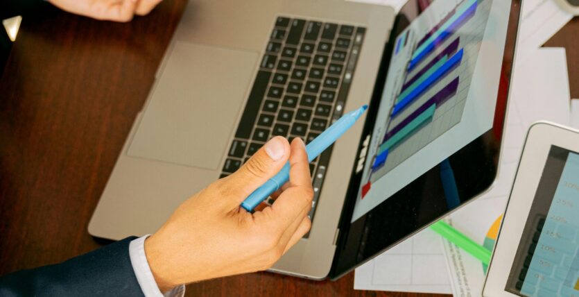 Free A Person in Black Suit Holding a Pen Stock Photo