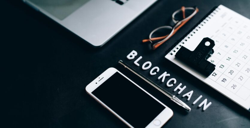 Free Flat lay of a modern digital workspace with blockchain theme, featuring a smartphone and calendar. Stock Photo
