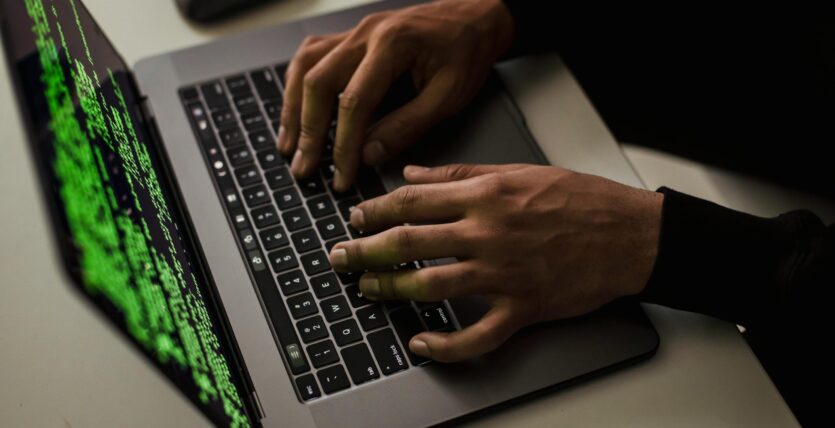 crop-cyber-spy-hacking-system-while-typing-on-laptop