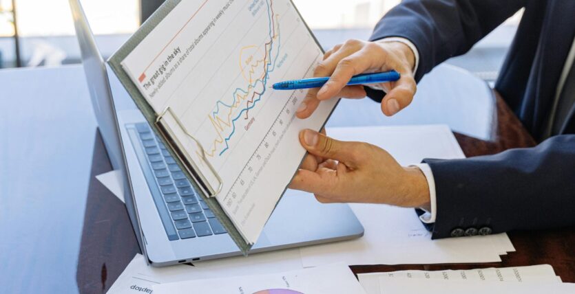 Free Business professionals discussing financial graphs and charts in an office setting. Stock Photo