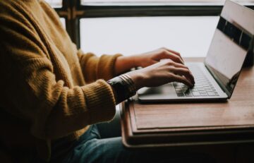 person sitting front of laptop