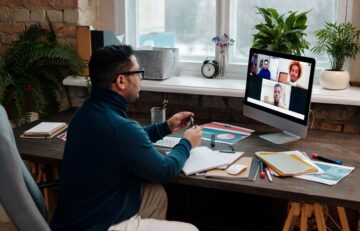 teacher-video-calling-with-his-students-using-a-computer