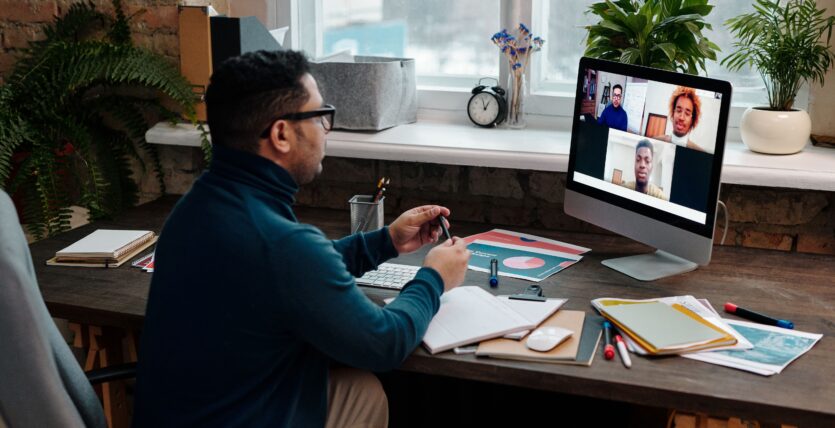 teacher-video-calling-with-his-students-using-a-computer